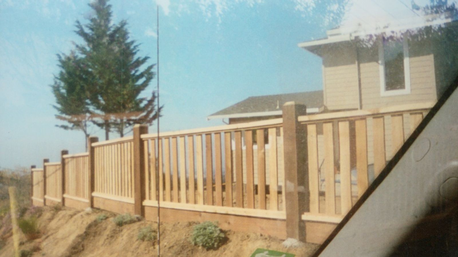 Wooden fence with vertical slats and decorative posts