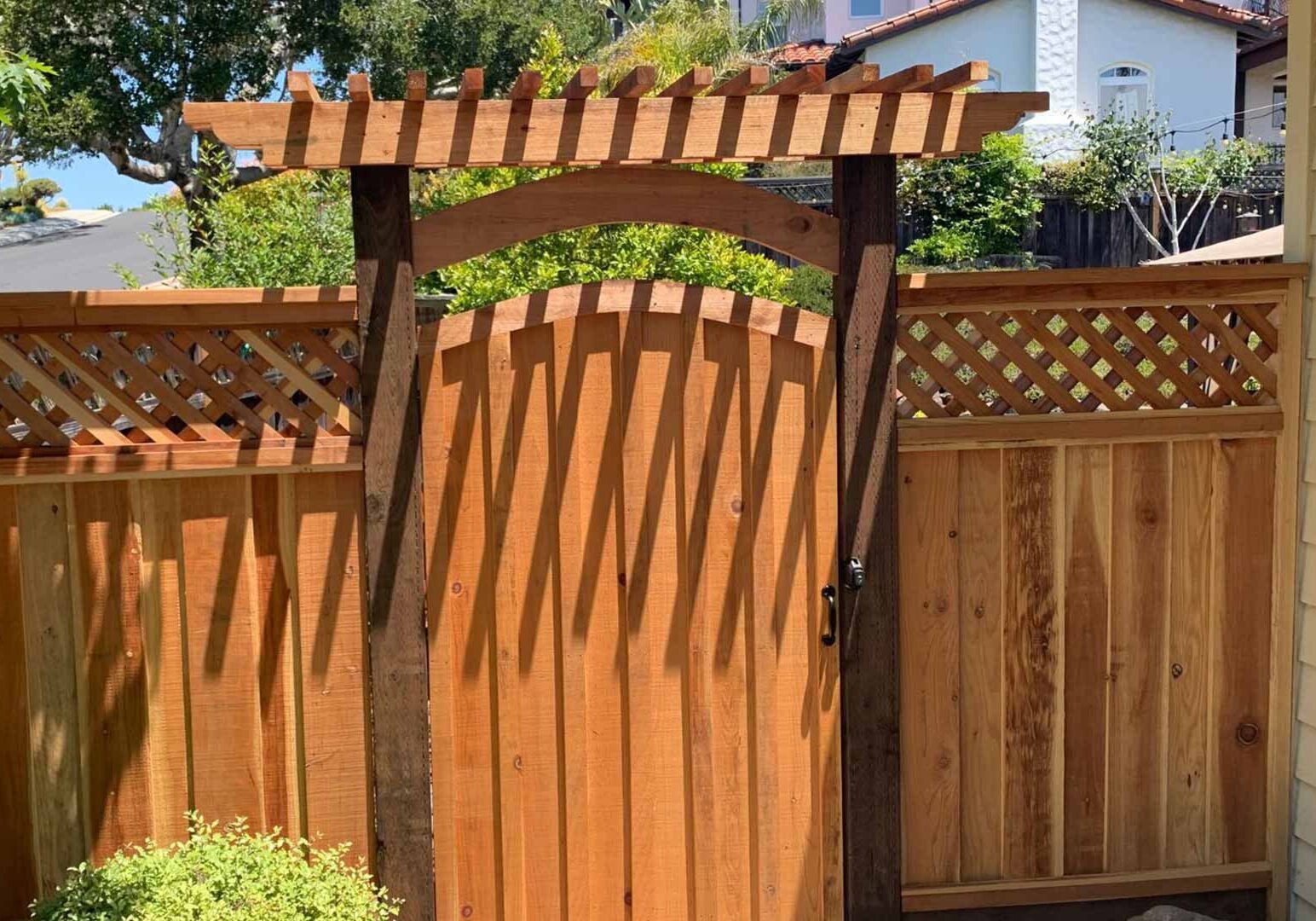 wooden garden gate set into a solid fence panel